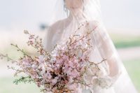 a fantastic and lush pink cherry blossom wedding bouquet is a gorgeous solution for a spring bride