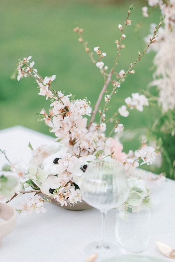 a lovely spring wedding centerpiece of blush cherry blossom and white anemons is a cool idea for a spring celebration