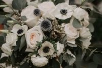 a lovely wedding bouquet of white roses, anemones, allium and eucalyptus and blue ribbons is amazing for spring or summer