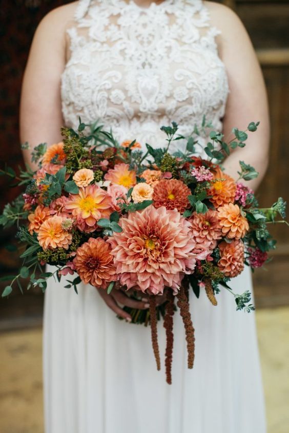 a monochromatic fall or summer to fall wedding bouquet with pink, dusty pink and yellow dahlias and greenery and lisianthus