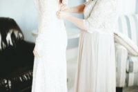 a neutral maxi dress with a lace bodice, short sleeves, a high neckline and a layered ombre skirt
