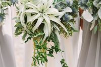 a neutral non-floral wedding bouquet with cascading greenery, air plants, succulents and thistles is amazing for a non-floral wedding