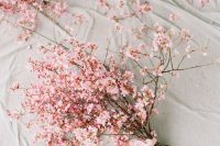 a pink cherry blossom wedding bouquet with pink ribbon is a lovely idea for a modern spring bride