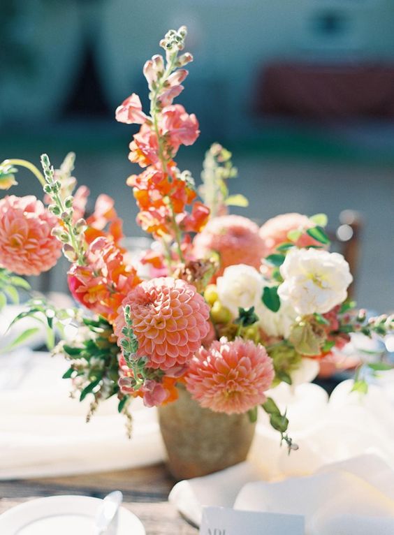 a pretty and simple wedding centerpiece of white and pink blooms, pink dahlias and a bit of greenery for summer