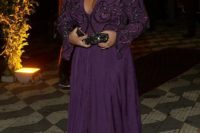 a purple maxi dress with slits, an embellished and embroidered bodice with a deep V-neckline and long sleeves