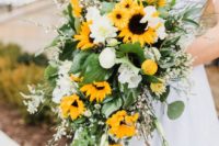 a romantic spring wedding bouquet of white blooms, sunflowers and willow pussy plus greenery