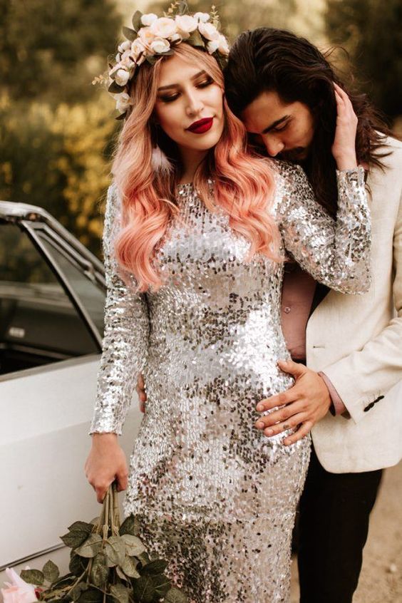 a silver sequin wedding dress with ombre blonde to straberry pink wavy hair and a floral crown