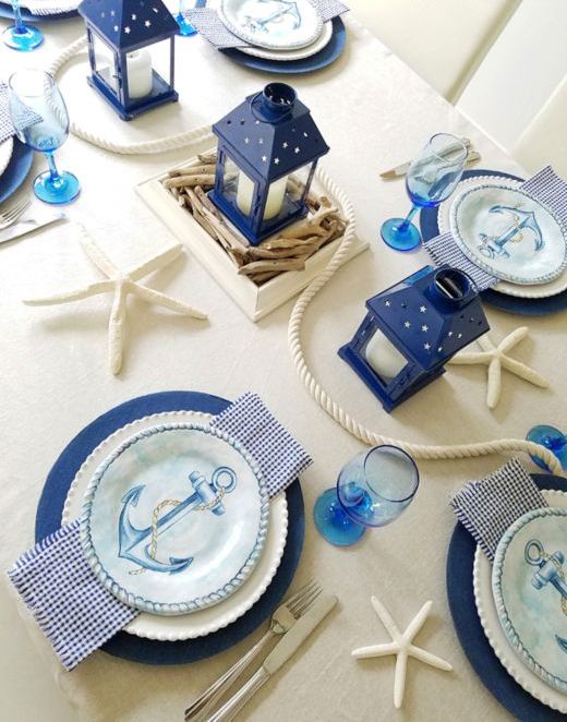 a simple nautical bridal shower setting in cream and navy plus bright blue touches, rope, starfish, anchor plates and candle lanterns