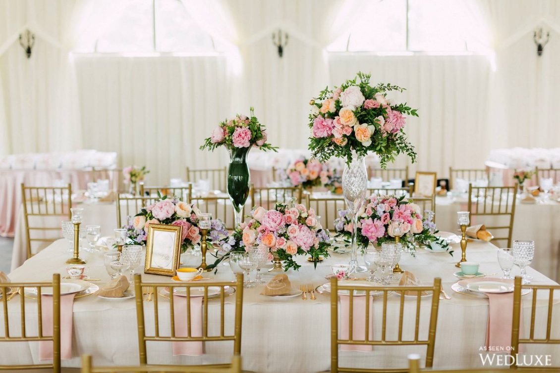 a sophisticated pink and white Parisian inspired bridal shower with pastel blooms and greenery, gold touches and pink napkins
