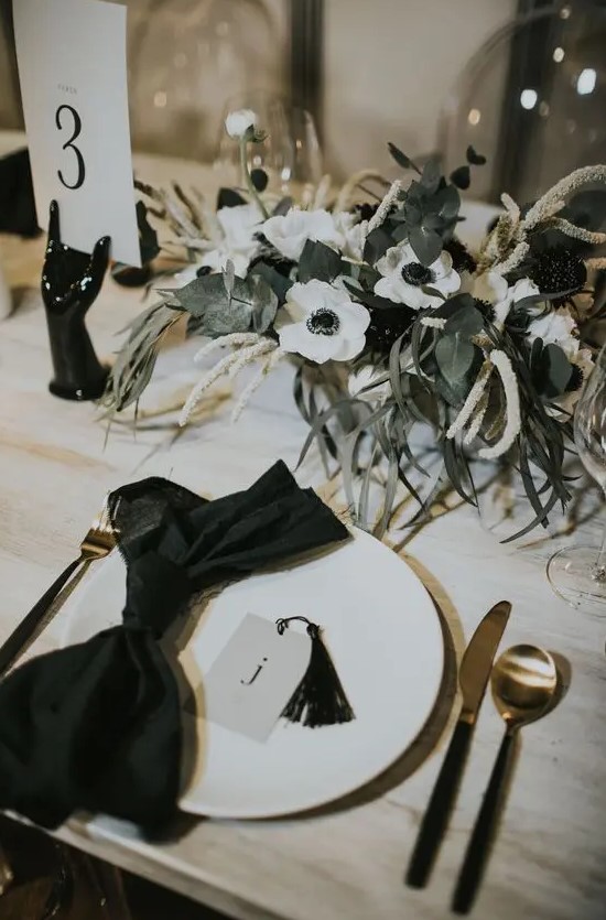 a stylish wedding centerpiece of white anemones, astilbe and greenery is a very elegant idea for a refined modern wedding