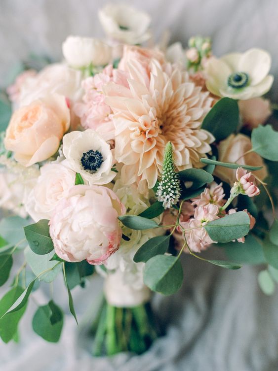 a super delicate blush wedding bouquet with white anemones, blush dahlias and peonies, astilbe and greenery