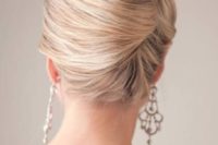 a super elegant and sleek French twist updo with a swirl, a volume and a sleek chignon will fit a formal wedding