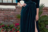 a teal velvet wrap maxi dress with a draped skirt and long sleeves plus a statement necklace and heels