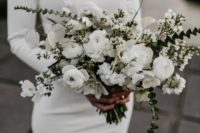a textural white wedding bouquet of ranunculus, lunaria, little blooms and greenery cascading and not only