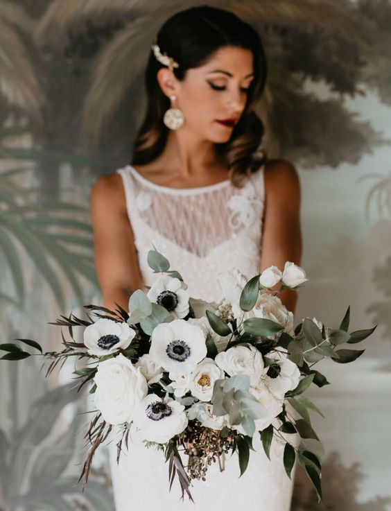 a white anemone wedding bouquet with greenery of various kinds is a chic and bold idea
