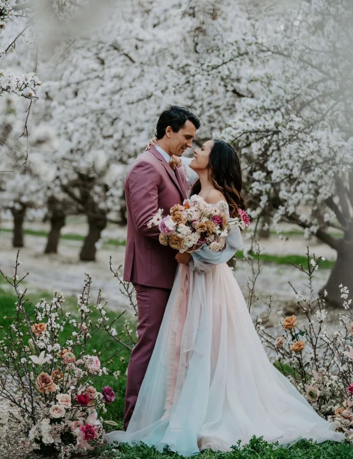 a white cherry blossom orchard and a wedding altar of cherry blossom and bright blooms for a gorgeous spring wedding