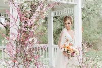 a white chuppah decorated with pink and white cherry blossom is a lovely idea for a spring wedding