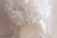 an airy white wedding bouquet of peonies and white silk ribbons is a heavenly beautiful idea