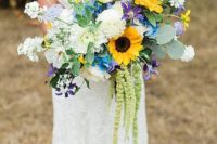 an elegant and colorful wedding bouquet of white and purple blooms, sunflowers, various kinds of greenery
