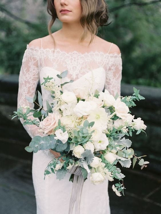 an elegant white bloom wedding bouquet with pale greenery and grey ribbons plus much dimension