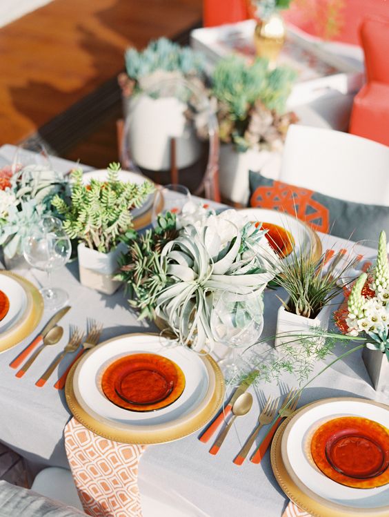 cluster wedding centerpieces of greenery, succulents and an air plant is a lovely solution for a bright boho wedding