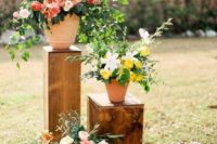 colorful blooms in pots on stands are nice for decorating a space, whether it’s a reception or a ceremony space