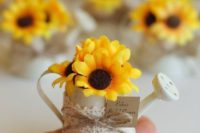 cute little water cans with sake sunflowers to give as whimsy wedding favors