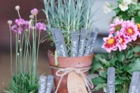 potted greenery and flowers with markers and table name tags are great centerpieces or just table numbers