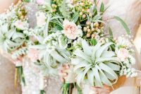 lovely wedding bouquets of blush blooms, airplants, greenery and berries are amazing for a spring or summer wedding