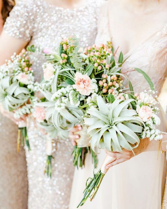 lovely wedding bouquets of blush blooms, airplants, greenery and berries are amazing for a spring or summer wedding
