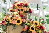 lush and bright wedding decor of sunflowers, blush and burgundy blooms, greenery and dark herbs