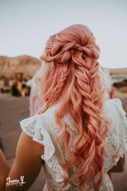 pink bridal hair with a bump on top, a double twisted halo and some braids and waves down for a boho bride