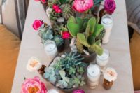 potted succulents and cacti plus blooms and candles make the table super bold, bright and cheerful