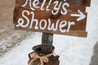 a rusty milk churn with a simple rustic sign is a nice and easy decoration for a cowgirl bridal shower