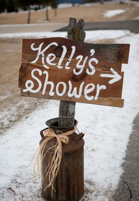 a rusty milk churn with a simple rustic sign is a nice and easy decoration for a cowgirl bridal shower