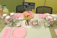a cozy and simple rustic table setting with grey and pink touches and blooms and a sign