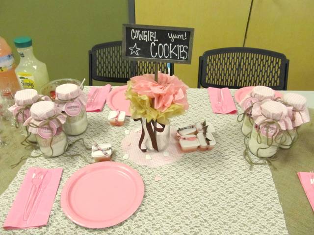 a cozy and simple rustic table setting with grey and pink touches and blooms and a sign
