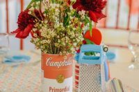 a colorful bridal shower tablescape with a bold floral centerpiece of burgundy and white blooms, a grater, a bold printed table runner
