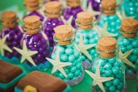 mermaid bridal shower favors or just candies on the dessert table – purple and turquoise ones in bottles, accented with starfish pendants