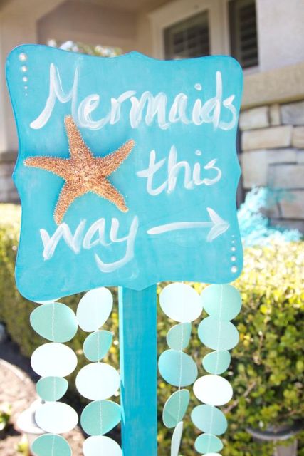 a blue mermaid bridal shower sign with seashells and a starfish is a cool solution that can be easily realized by you yourself