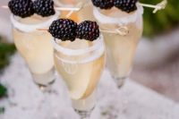 Glass of champagne with blackberry decor