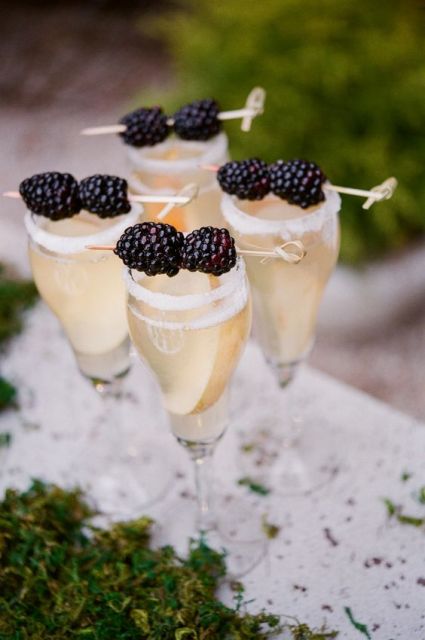 Glass of champagne with blackberry decor