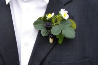 Groom boutonniere with blackberries