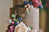 Wedding cake with flowers, ripe and unripe blackberries