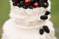 White wedding cake with blackberries