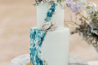 a catchy light green cake with gorgeous teal and navy detailing, seashells, corals and pearls is amazing for your mermaid bridal shower