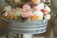 a metal cupcake tier stand instead of a big cake is a great dessert option with a rustic feel