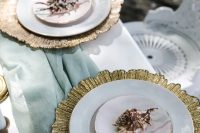 a refined mermaid bridal shower tablescape with a mint green table runner, gold placemats and neutral and pastel porcelain, gilded seashells and candles
