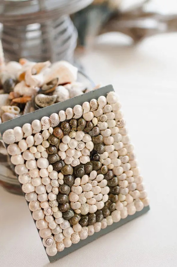 a seashell incrusted table number looks wow and will instantly add a sea feel to your bridal shower tablescape