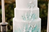 a white and green mermaid bridal shower cake with swirls, pearls and sand is a fantastic idea with a touch of color